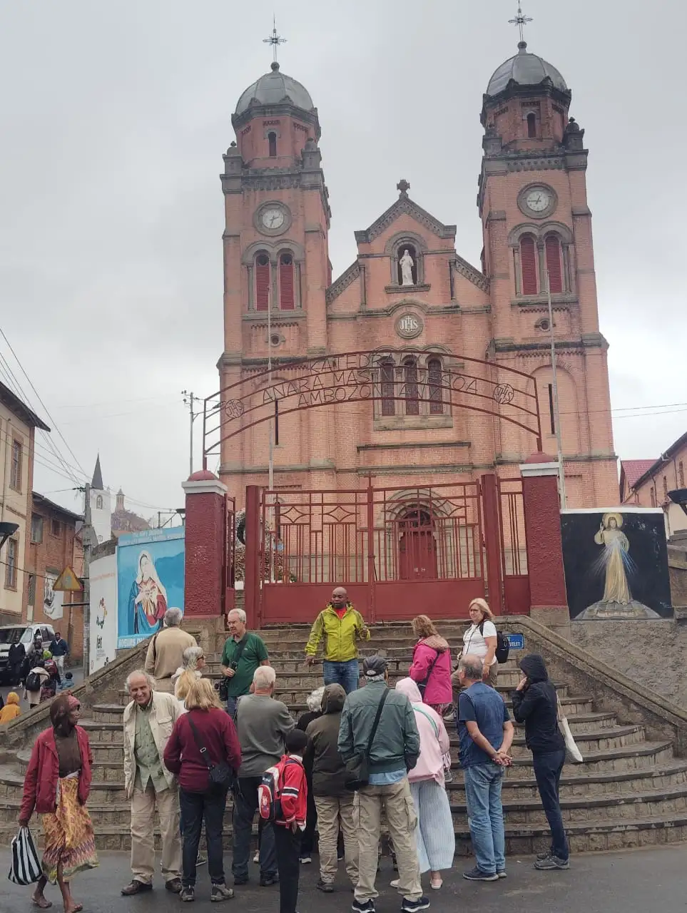 Travellers with their guide in front of Ambozontany Cathedral, Fianarantsoa